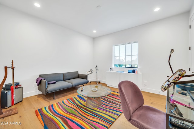 home office featuring radiator heating unit and light wood-type flooring