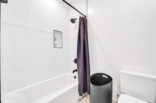 bathroom featuring shower / bath combination with curtain and toilet