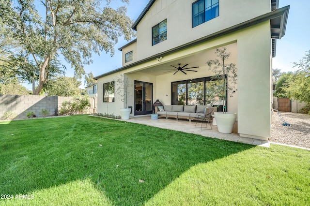 back of property featuring outdoor lounge area, a yard, a patio, and ceiling fan