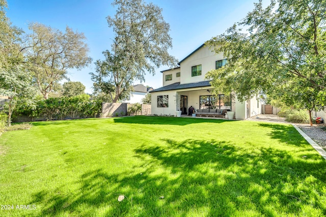 exterior space with an outdoor living space and a yard