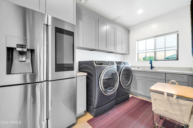 washroom with sink and washing machine and clothes dryer