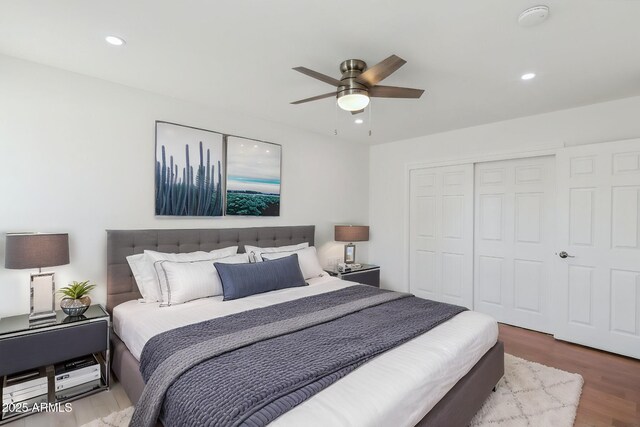 kitchen with white cabinets, appliances with stainless steel finishes, sink, and light hardwood / wood-style flooring