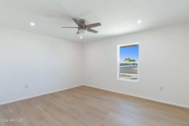 spare room featuring ceiling fan and hardwood / wood-style flooring