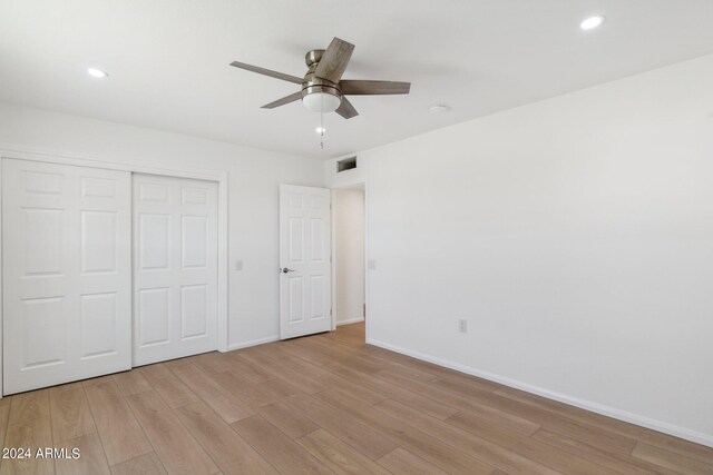 empty room with wood-type flooring and ceiling fan