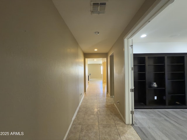hall with visible vents, baseboards, recessed lighting, and light tile patterned floors