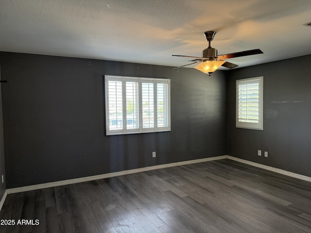 unfurnished room with baseboards, a textured ceiling, a ceiling fan, visible vents, and wood finished floors