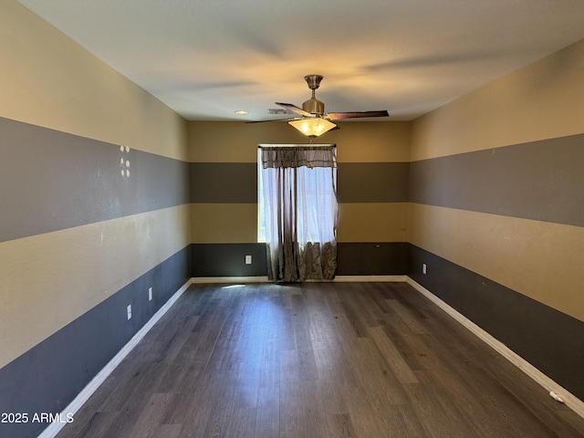 unfurnished room with baseboards, a ceiling fan, and wood finished floors