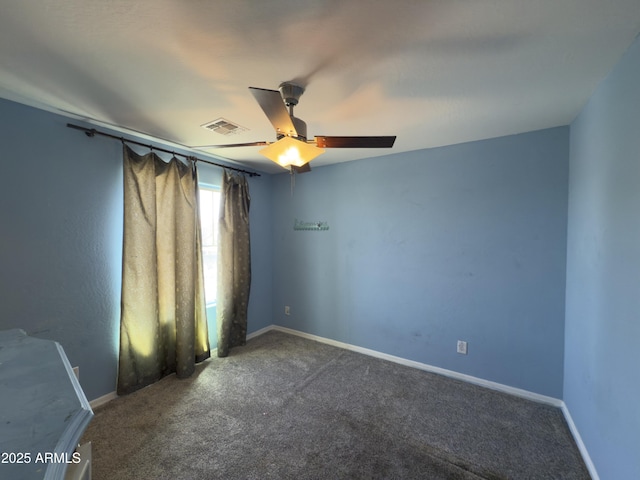 carpeted spare room featuring visible vents, baseboards, and ceiling fan