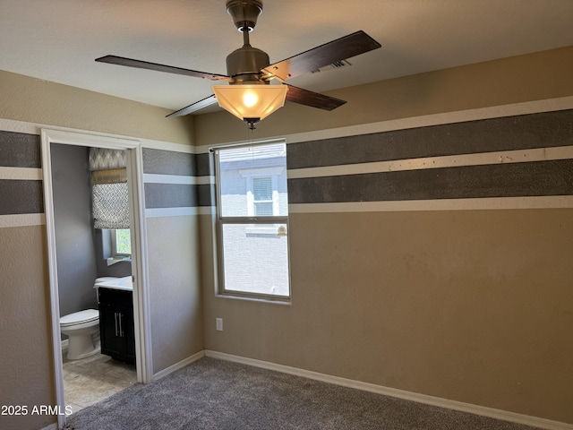 unfurnished bedroom with ceiling fan, multiple windows, baseboards, and carpet floors