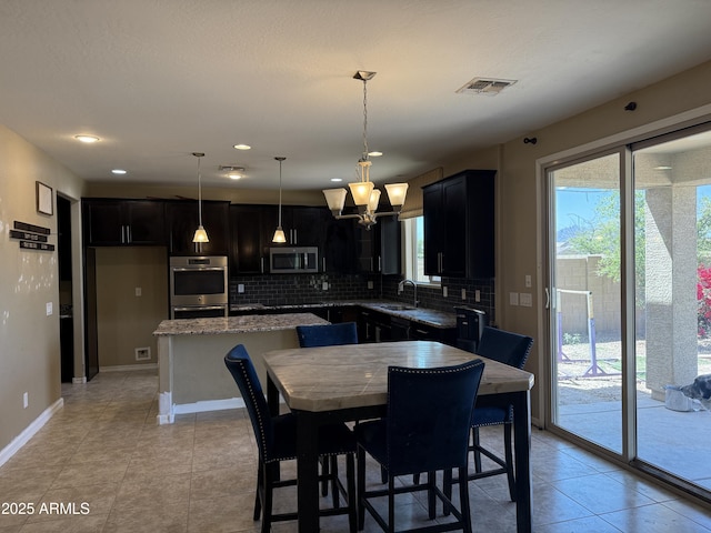 dining space featuring light tile patterned flooring, baseboards, visible vents, and a wealth of natural light
