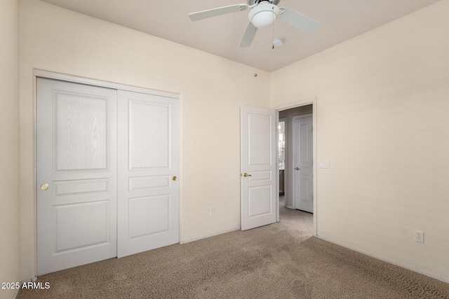 unfurnished bedroom with ceiling fan, light colored carpet, and a closet