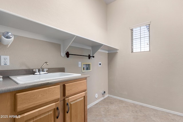 washroom featuring sink, electric dryer hookup, washer hookup, and cabinets