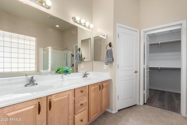 bathroom featuring vanity, tile patterned flooring, and a shower with shower door