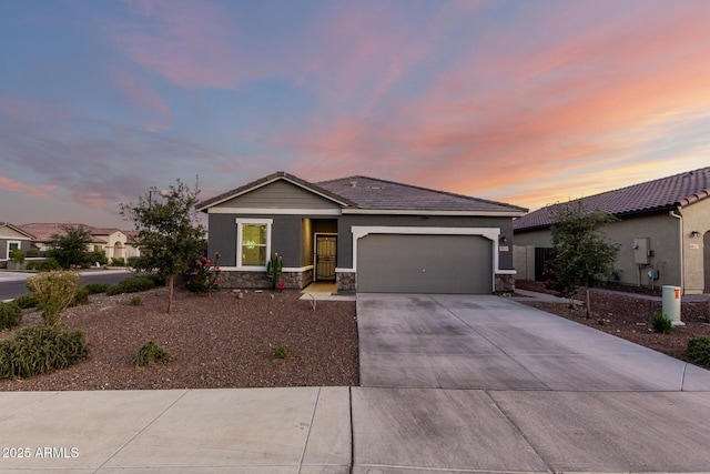 19531 W Palo Verde Dr, Litchfield Park, AZ 85340 - ranch-style house featuring a garage, stone siding, driveway, and a tile roof