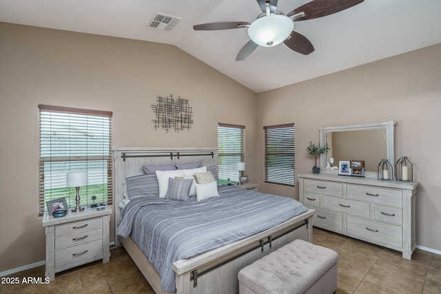 bedroom with ceiling fan, vaulted ceiling, and light tile patterned floors