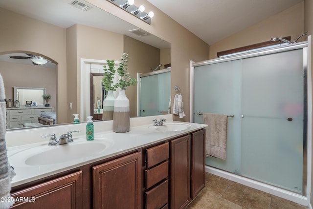 bathroom with an enclosed shower, vanity, tile patterned flooring, and lofted ceiling