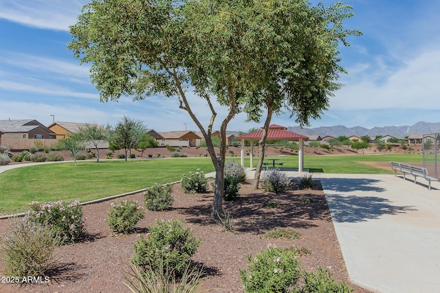 surrounding community featuring a mountain view, a gazebo, and a lawn