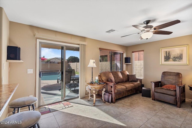 tiled living room featuring ceiling fan