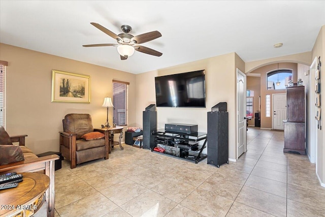 living room featuring light tile patterned floors and ceiling fan