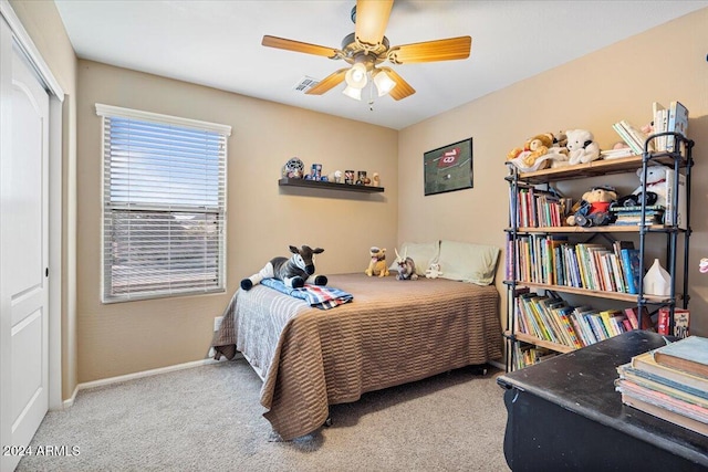 carpeted bedroom with a closet and ceiling fan