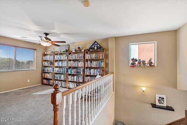 interior space featuring ceiling fan and carpet floors