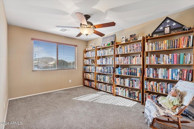 living area with ceiling fan and carpet floors