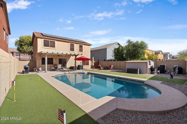 view of pool with a storage unit, area for grilling, and a patio