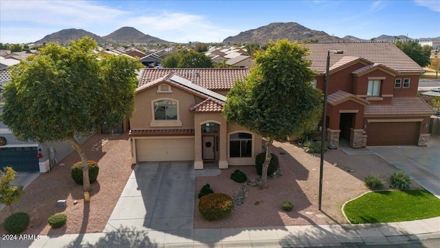 view of front of property with a mountain view and a garage