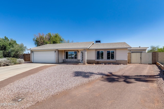 7210 W Caron Dr, Peoria, AZ 85345 - ranch-style house with concrete driveway, an attached garage, a gate, and brick siding