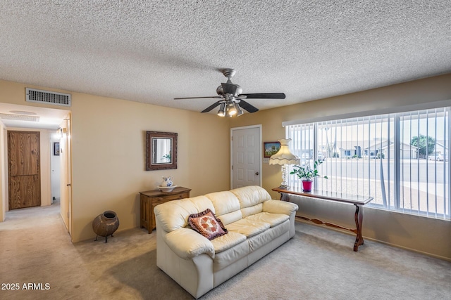7210 W Caron Dr, Peoria, AZ 85345 - living room featuring light carpet, a ceiling fan, and a textured ceiling
