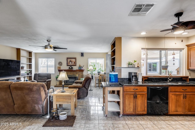7210 W Caron Dr, Peoria, AZ 85345 - kitchen with a ceiling fan, a sink, open floor plan, brown cabinets, and recessed lighting