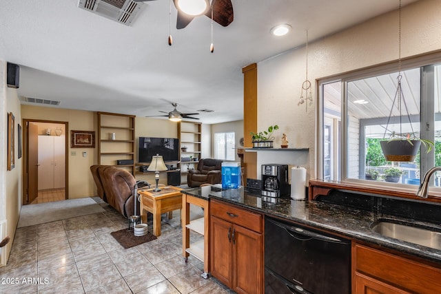 7210 W Caron Dr, Peoria, AZ 85345 - kitchen with a ceiling fan, black dishwasher, a sink, open floor plan, and brown cabinets