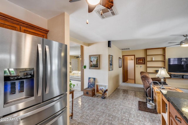 7210 W Caron Dr, Peoria, AZ 85345 - kitchen with ceiling fan, stainless steel fridge, open floor plan, a desk, and dark stone countertops