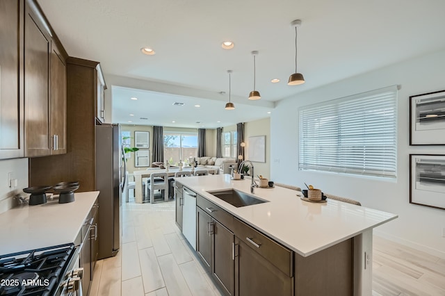 10105 E Ulysses Ave, Mesa, AZ 85212 - kitchen featuring a sink, appliances with stainless steel finishes, dark brown cabinetry, recessed lighting, and light countertops