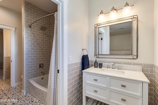 bathroom featuring vanity, tile walls, shower / tub combo, and tile patterned floors