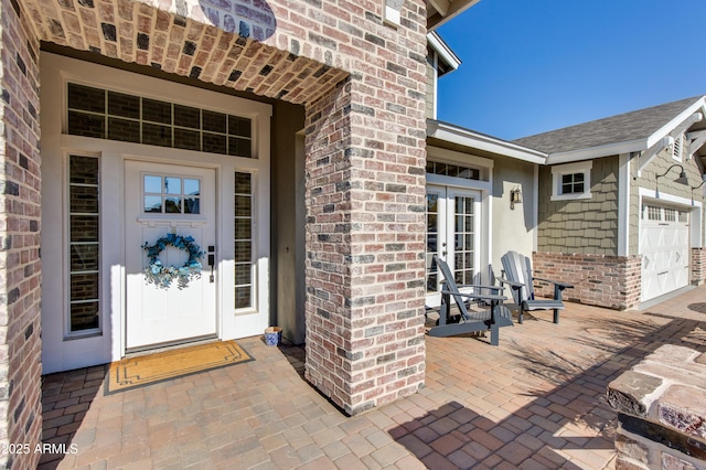 entrance to property with french doors and a garage