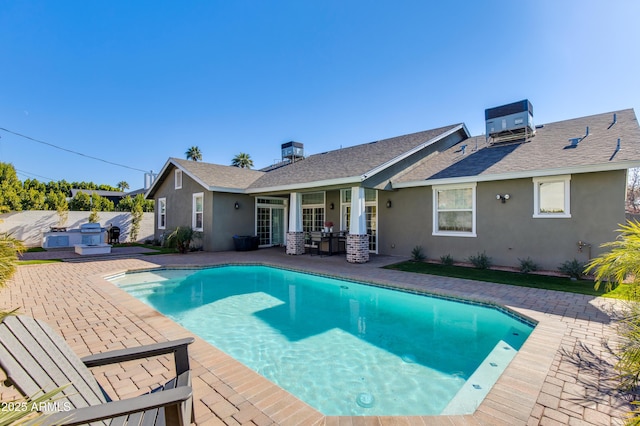 view of pool featuring a patio and central AC unit