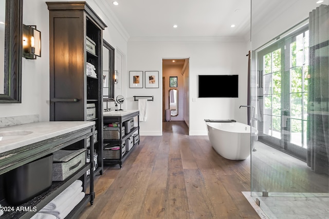 5929 E Indian School Rd, Phoenix, AZ 85018 - full bathroom with two vanities, a freestanding bath, ornamental molding, wood finished floors, and baseboards