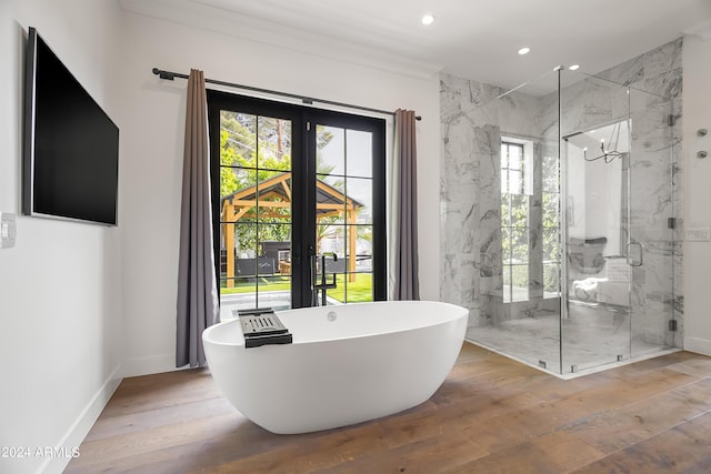 5929 E Indian School Rd, Phoenix, AZ 85018 - full bathroom with healthy amount of natural light, a marble finish shower, a soaking tub, ornamental molding, and french doors
