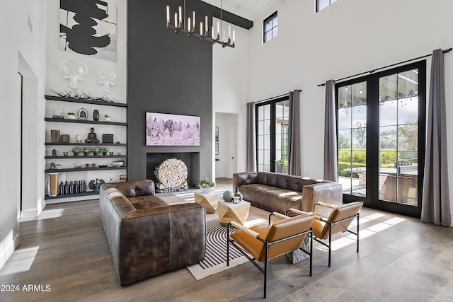 5929 E Indian School Rd, Phoenix, AZ 85018 - living room with wood finished floors, a towering ceiling, french doors, and a chandelier
