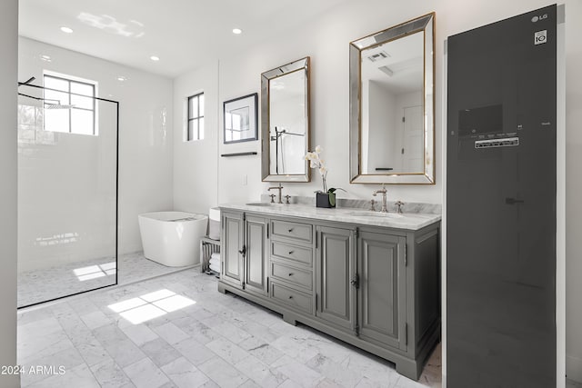 5929 E Indian School Rd, Phoenix, AZ 85018 - bathroom featuring a freestanding tub, double vanity, walk in shower, and recessed lighting