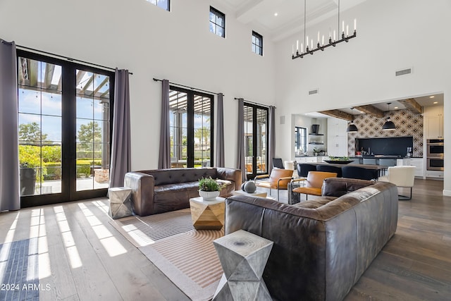 5929 E Indian School Rd, Phoenix, AZ 85018 - living room featuring french doors, wood-type flooring, beam ceiling, and a high ceiling