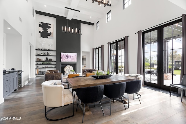 5929 E Indian School Rd, Phoenix, AZ 85018 - dining area featuring french doors, a high ceiling, beverage cooler, wood-type flooring, and beam ceiling