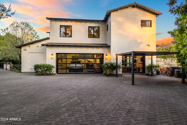 5929 E Indian School Rd, Phoenix, AZ 85018 - view of front of house featuring decorative driveway, stucco siding, and a garage