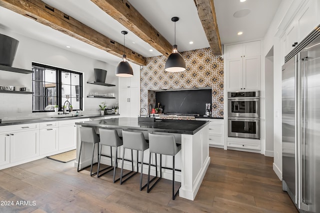 5929 E Indian School Rd, Phoenix, AZ 85018 - kitchen with open shelves, stainless steel appliances, a sink, recessed lighting, and dark wood-style flooring