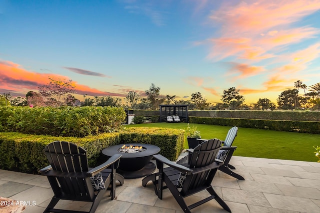 5929 E Indian School Rd, Phoenix, AZ 85018 - patio terrace at dusk with a fire pit, a patio, and a yard