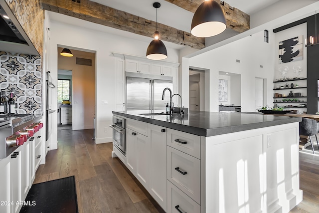 5929 E Indian School Rd, Phoenix, AZ 85018 - kitchen featuring dark countertops, a sink, dark wood finished floors, beam ceiling, and extractor fan
