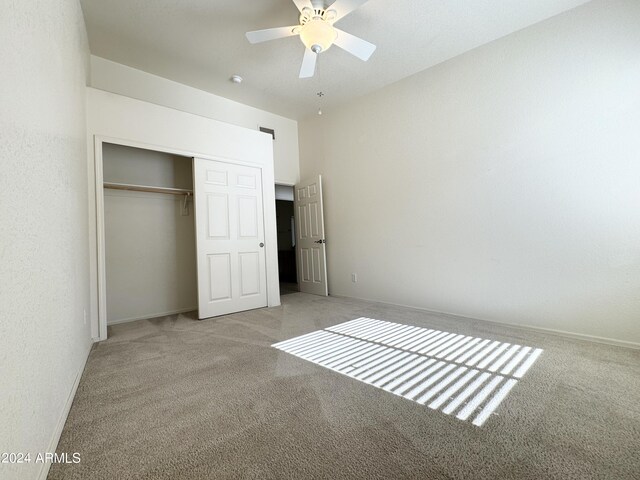 unfurnished bedroom featuring carpet floors, a closet, and baseboards