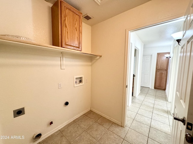 laundry area with cabinet space, light tile patterned floors, visible vents, hookup for a washing machine, and electric dryer hookup