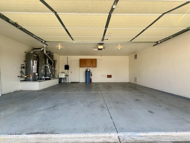 garage featuring water heater and a garage door opener